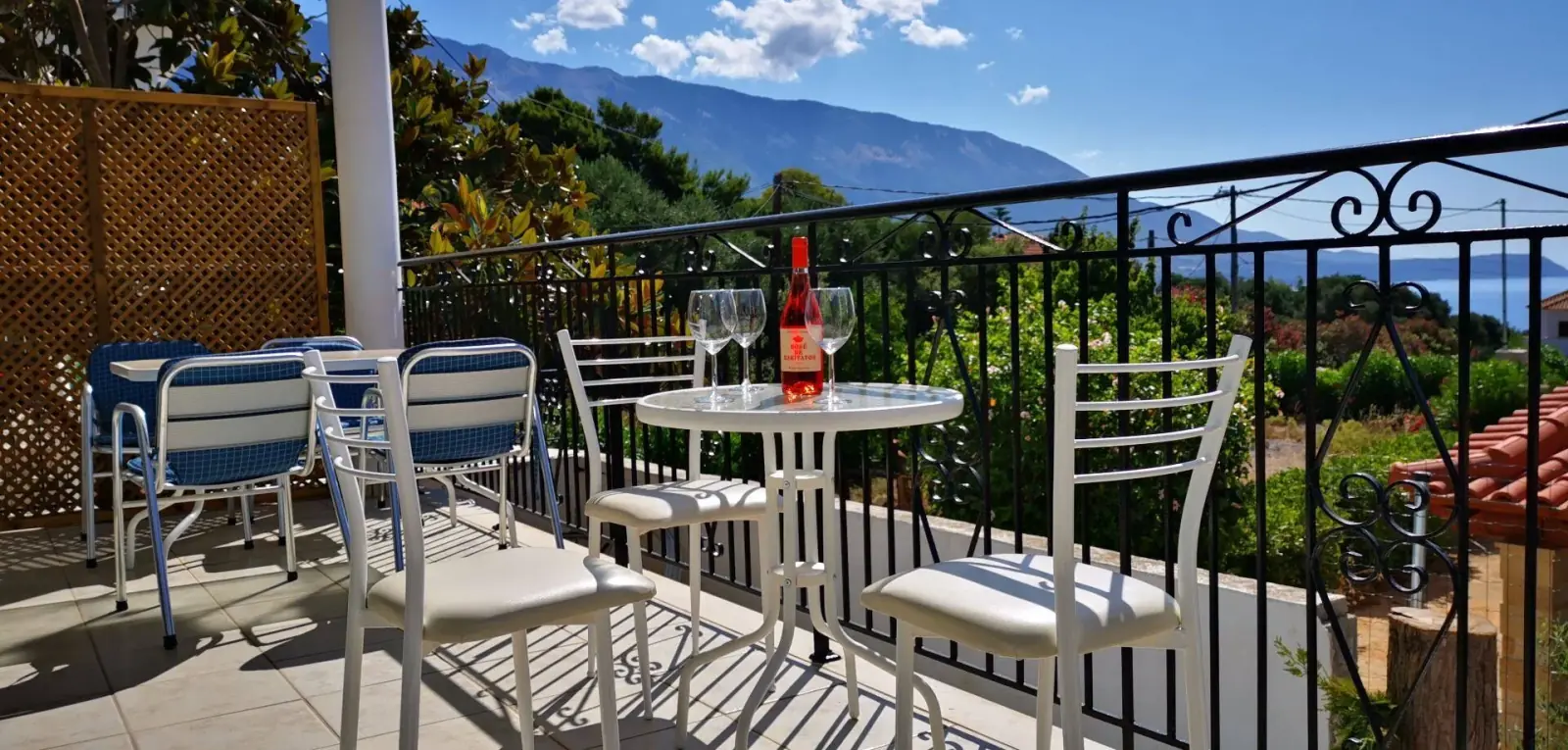 Terrace with sea view, rosé wine and Mount Ainos in the distance